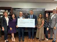 Entergy Texas and Comcast present Community Assistance Center with $20,000 check