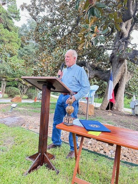 Steve Kasmiersky Jr. shares his reflections of the tree and of his fathers’ time when they developed McDade Estates in the late 1960s and early 1970s.  In the background, the old magnolia tree shows her age with its hollow center.    Photo credit: Mark Canada