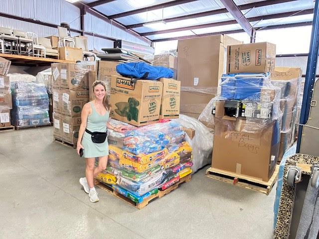 Sarah Bartholet Gwin showing pallets of supplies