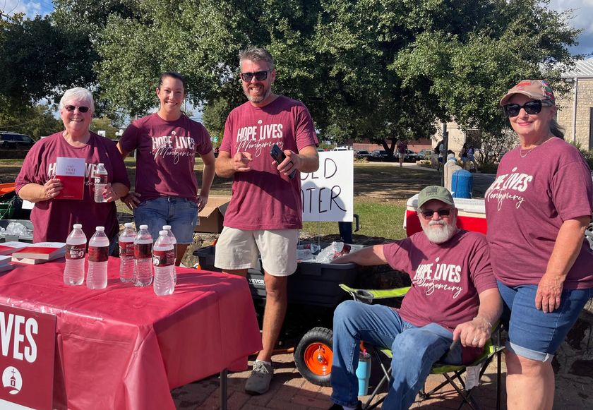 Members of the Church at Montgomery, handing out Bibles and Water