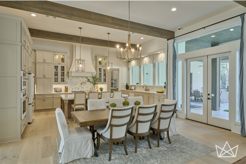 Beautiful dining and kitchen view with large window views and French doors leading to the spacious back patio designed by Royal Texan Homes